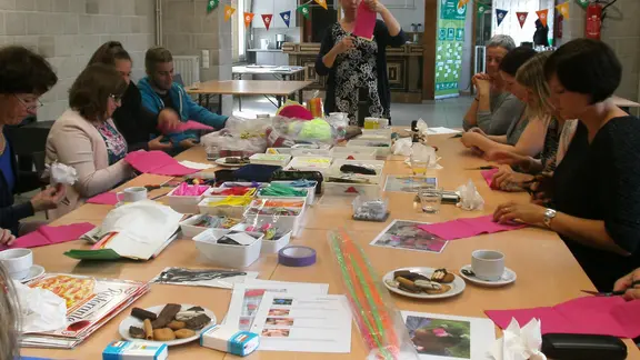 jongeren rond een tafel volgen de workshop gekke kapsels